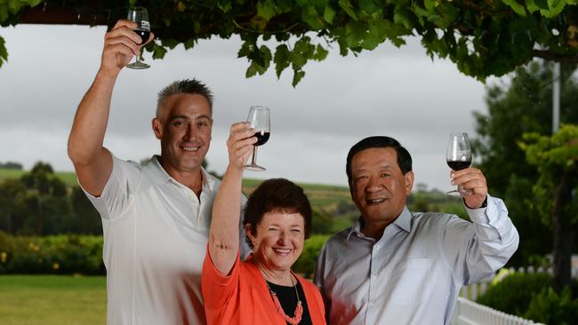 Onkaparinga mayor and LGA president Lorraine Rosenberg with Onkaparinga chief executive Mark Dowd, left, and magistrate Su Jingwen, right, at the McLaren Vale visitor centre. Photo: Naomi Jellicoe