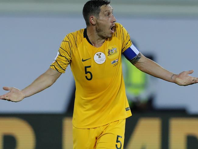 Australia's midfielder Mark Milligan, gestures to referee during the AFC Asian Cup group B soccer match between Australia and Syria at the Khalifa bin Zayed Stadium in Al Ain, United Arab Emirates, Tuesday, Jan. 15, 2019. (AP Photo/Hassan Ammar)