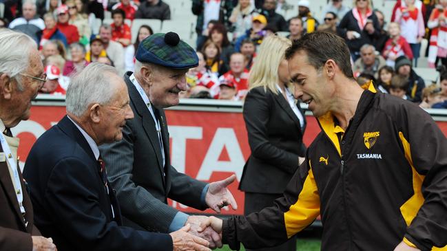 Alastair Clarkson shakes the hands of Kokoda veterans before a game.