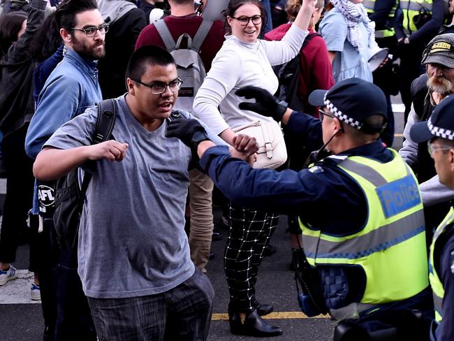 Students protest outside a Liberal Party function at the Docklands in Melbourne, where Prime Minister Malcolm Turnbull and former Prime Minister John Howard are speaking. Picture: Andy Brownbill