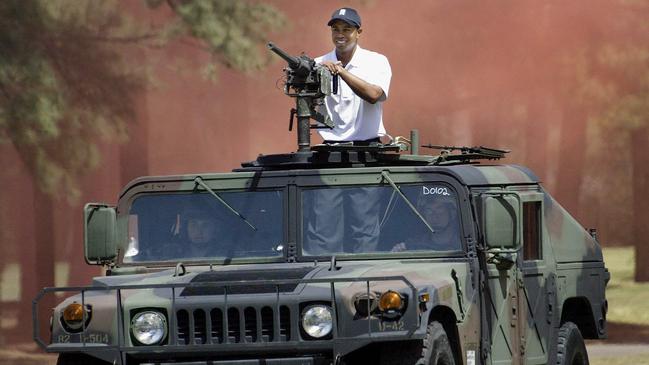 Golf legend Tiger Woods in a military Hummer.