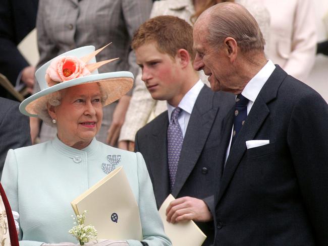 Prince Harry with his grandparents during a service for her 80th birthday in 2006. Picture: Supplied