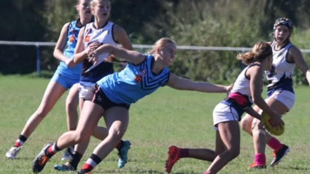 Charlotte Schubert reaching for a tackle in her 50th match for Wynnum.