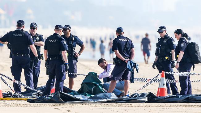 Police at the scene where a male body was discovered on a Surfers Paradise beach this early this morning. Picture: NIGEL HALLETT