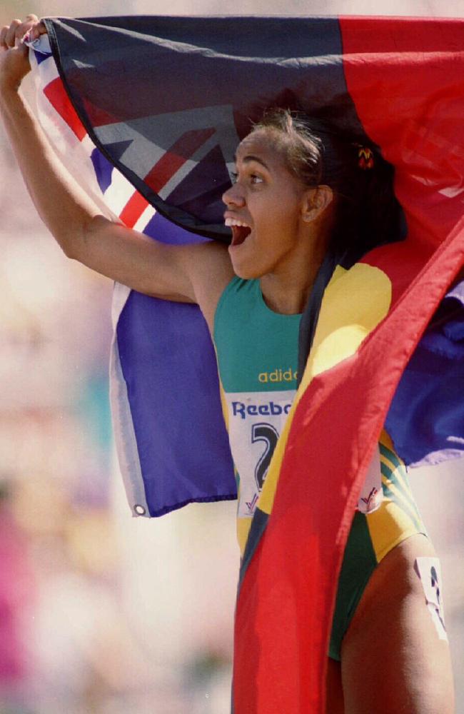 Gold medal winning runner Cathy Freeman repeatedly wrapped herself in both Australian and Aboriginal flags, most notably at the 2000 Sydney Olympic Games. Picture: John Feder