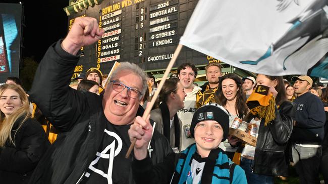 SEPTEMBER 13, 2024: Port fans Michael Kowal and son Mitchell 11yo from Woodville West celebrate a goal during the Port v Hawthorn semi final at Adelaide Oval. Picture: Brenton Edwards