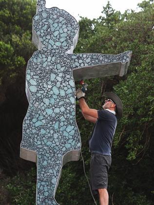 Artist Matt Calvert putting the finishing touches on his Girl Pointing.