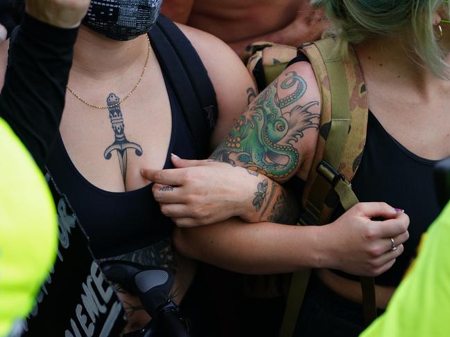 People lock arms while facing a police line during a protest in response to the police killing of George Floyd outside the CNN Center in Atlanta, Georgia. Picture: Getty