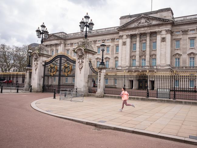 A jogger runs along the deserted footpaths around Buckingham Palace. Picture: Getty Images