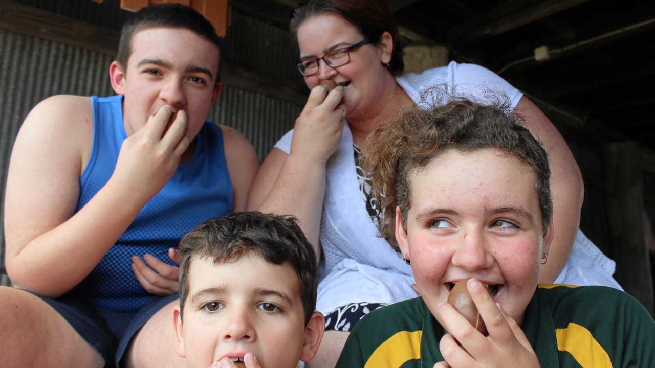 Cassie Stone and her children Jackson, Chad and Chonteal share a Kinder Surprise in honour of Robert Agius. Picture: Jarred Sferruzzi