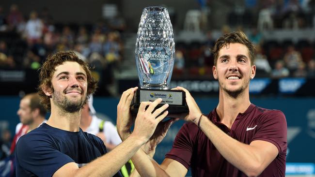 Kokkinakis (R) and Thompson pose with the Brisbane doubles trophy.