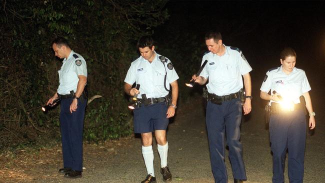 Police look for evidence outside the Brookfield home of journalist Hedley Thomas after the shooting. Picture: Giulio Saggin