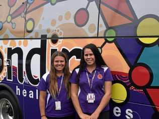 READY TO ROLL: Goondir Health Services employees Mardi-Leigh Rolls and Charlie Thomas in front of the clinics bus. Picture: Sam Flanagan