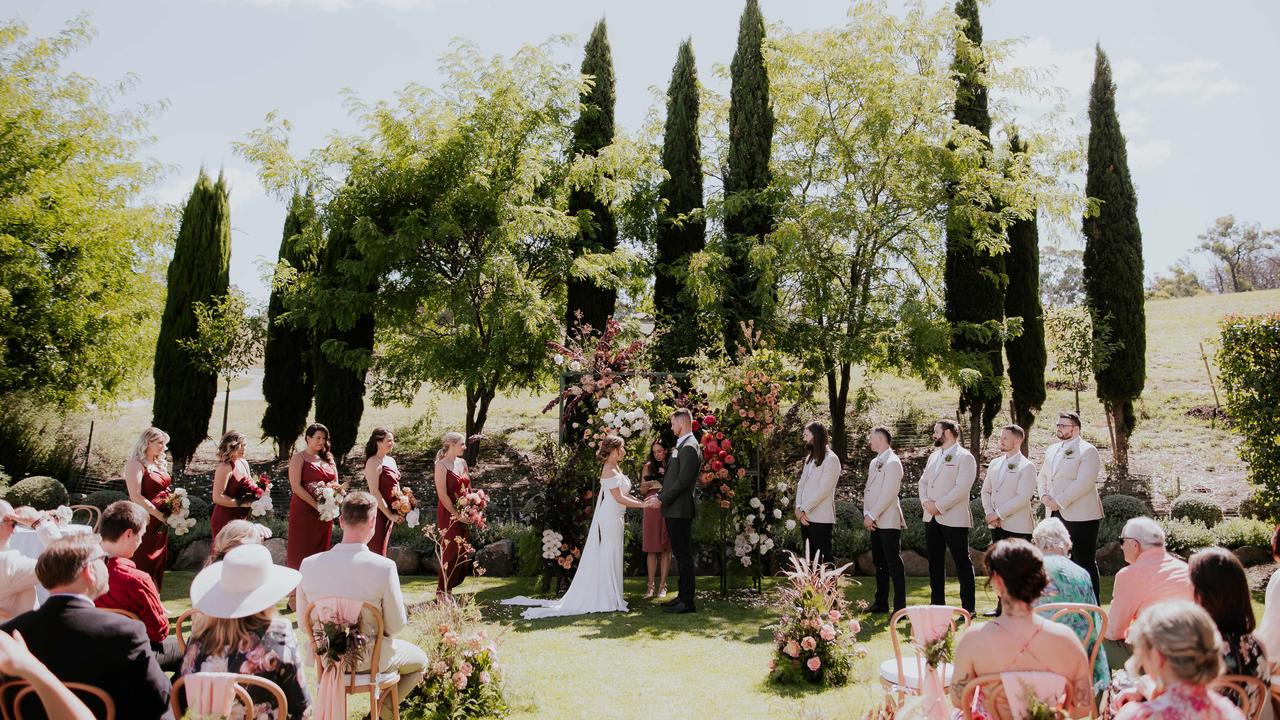 Kylie and Ben's whimsical garden party featured bright blooms and an appropriately colourful bridal party. Picture: Travis and Benny