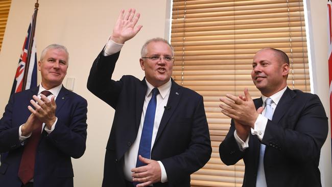 (L-R) Australian Deputy Prime Minister Michael McCormack, Australian Prime Minister Scott Morrison and Federal Treasurer Josh Frydenberg react during a Coalition party room meeting at Parliament House in Canberra, Tuesday, May 28, 2019. (AAP Image/Lukas Coch) NO ARCHIVING