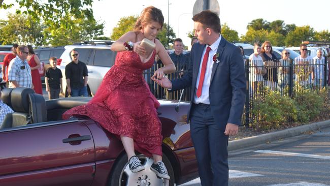 Abigail Wainwright was helped by Bayley Everett out of their formal ride when the couple arrived at the Mackay Northern Beaches State High School formal, on Saturday October 17. Picture: Zizi Averill