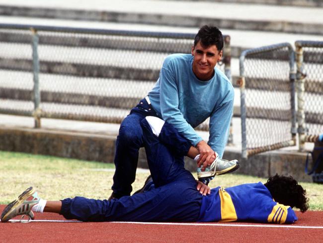 Nic Bideau helps Cathy Freeman stretch. Picture: Tony Feder