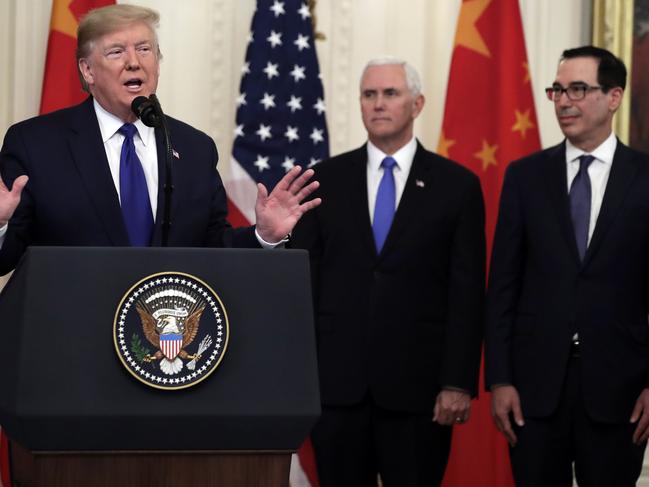 President Donald Trump speaks before signing a trade agreement as Vice President Mike Pence and Treasury Secretary Steven Mnuchin listen. Picture: AP