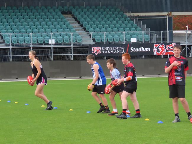 Kids taking part in drills at the Devils school holiday clinic at Launceston on Tuesday. Picture: Jon Tuxworth