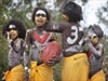 Aboriginal dancers with red and white paint to support Adam Goodes