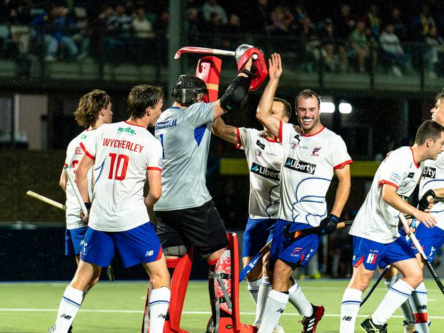 Adelaide Fire Hockey One goalkeeper Jed Snowden with teammates. Picture: Andrew Castles.