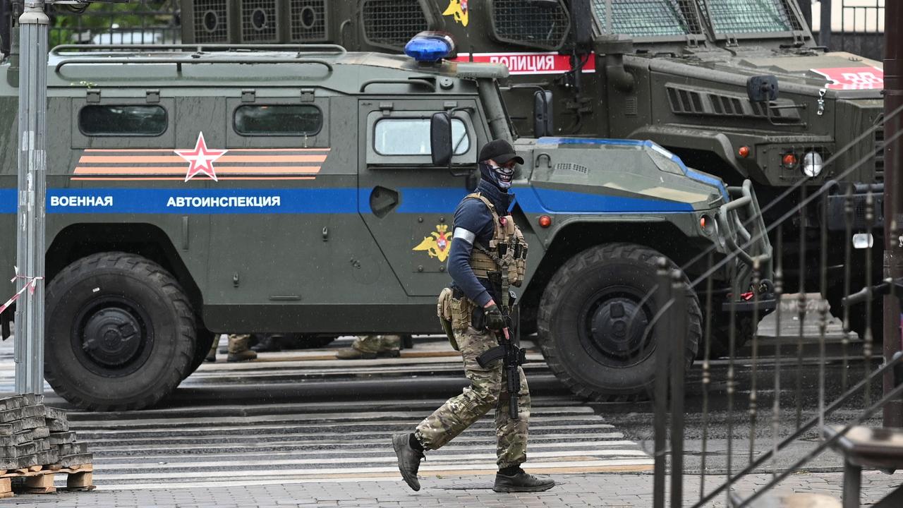 A fighter of Wagner private mercenary group patrols a street near the headquarters of the Southern Military District in the city of Rostov-on-Don. Picture: REUTERS/Stringer