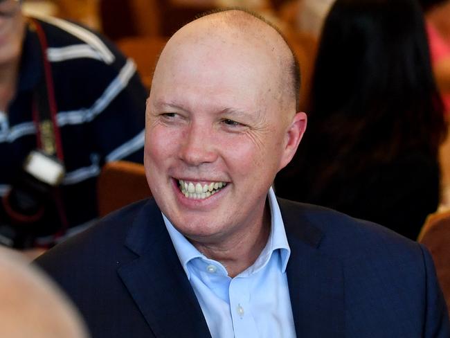 Australia's Minister for Home Affairs, Peter Dutton (centre) is seen with diners at the Golden Lane Chinese Restaurant in Brisbane, Friday, February 28, 2020. Minister Dutton is encouraging Australians to keep eating out at Chinese restaurants as they have seen a drop in customers since the outbreak of the COVID-19 coronavirus. (AAP Image/Darren England) NO ARCHIVING