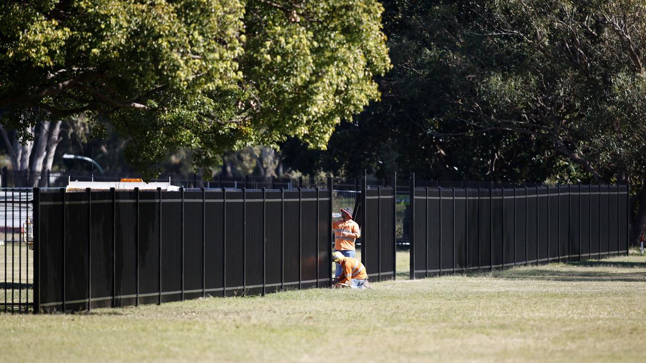 Workers installing the fence at Kedron. Picture: Josh Woning