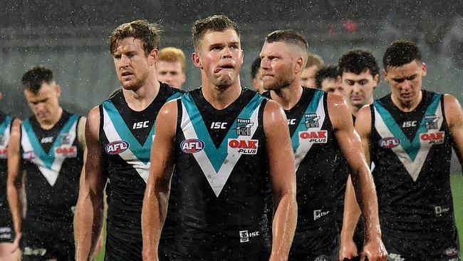 Port Adelaide players trudge off Adelaide Oval after the loss to Western Bulldogs on Saturday night. Picture: Mark Brake/Getty Images