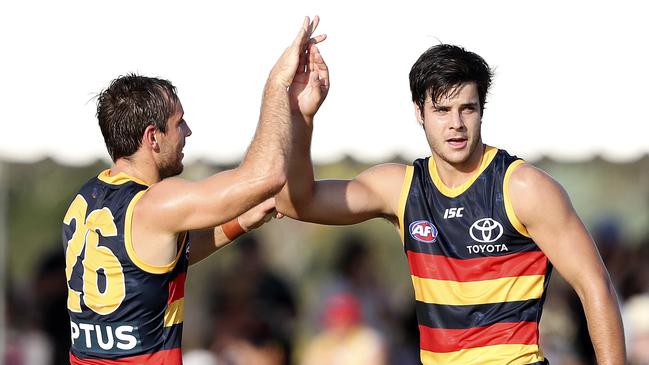 Darcy Fogarty celebrates a goal with Richard Douglas during the JLT Series. He has been unable to crack into the Crows’ line-up this season. Picture SARAH REED