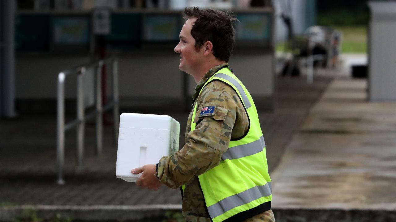 Testing for coronavirus was done locally on Christmas Island before samples were sent to Sydney’s Westmead Hospital to confirm the results. Pictured is a coronavirus test sample being taken to a waiting RAAF Hercules at Christmas Island airport. Picture Colin Murty The Australian