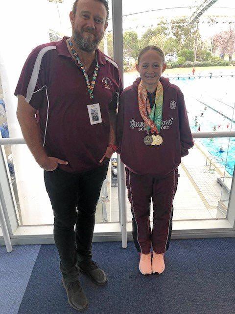 Coach Shane Kingston with Taryn Roberts after her three gold medal haul at the national schools championships. Picture: CONTRIBUTED