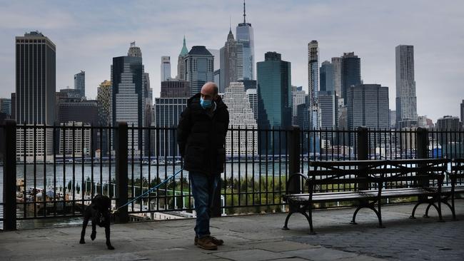 A man walks his dog along a promenade in Brooklyn, New York City. Picture: Getty Images