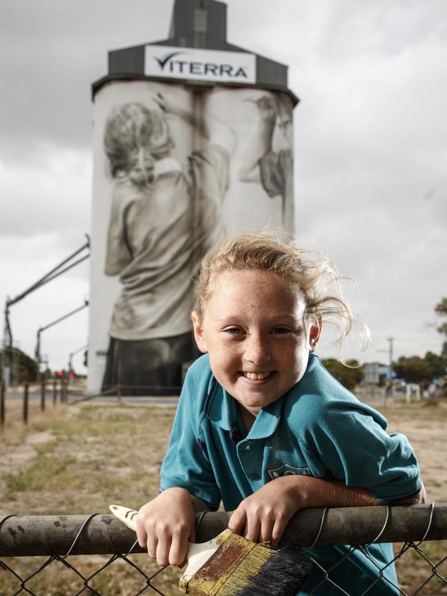 Ciara Johnson with her likeness on the silo. Picture: Matt Turner