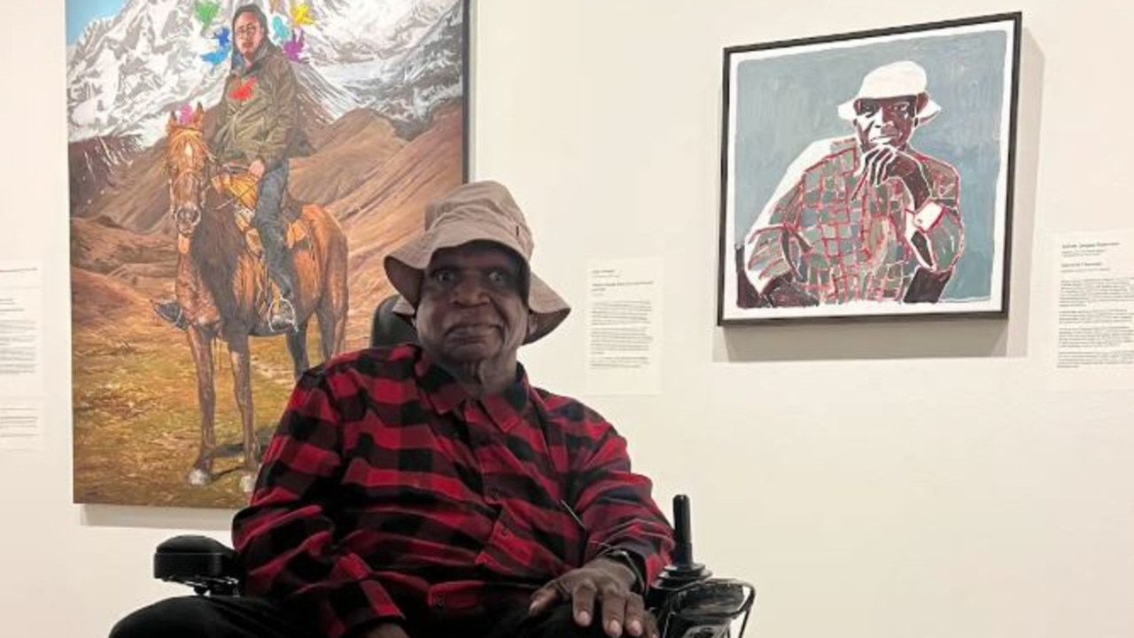 Mr Robertson sat in front of Clara Adolphs portrait of him (right). Picture: Supplied