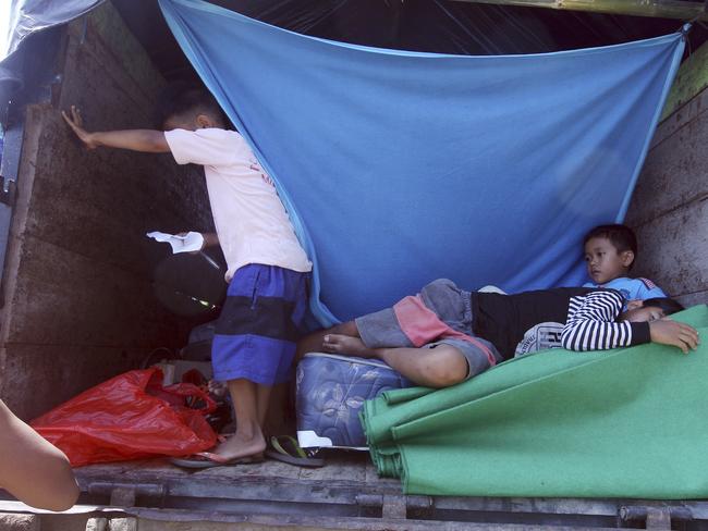Children stay in a truck as their temporary shelter in Klungkung, Bali. Picture: AP