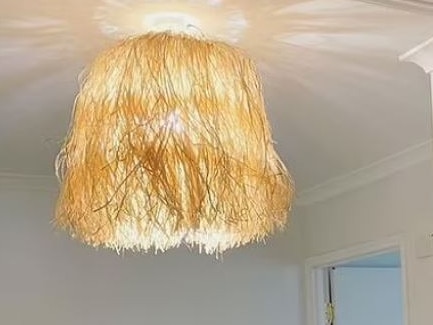 Woman took to Facebook to share her Kmart seagrass light shade hack. Picture: Facebook