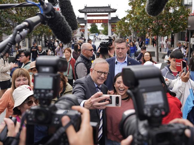 SYDNEY, AUSTRALIA - APRIL 28: Australian Prime Minister Anthony Albanese takes photographs with members of the public during a visit to Freedom Plaza in the suburb of Cabramatta in the electorate of Fowler on April 28, 2025 in Sydney, Australia. Albanese hit the campaign trail again for the final week leading into the election on Monday, after he was declared the narrow winner of the final leaders' debate, securing the support of 50 percent of the studio's undecided voters, compared to Peter Dutton's 25 percent, while the remainder stayed undecided. Albanese's performance was marked by a positive closing message focused on optimism and investment in Australia's future, though he faced criticism for stumbling over a key question on cost-of-living relief. (Photo by Asanka Ratnayake/Getty Images)