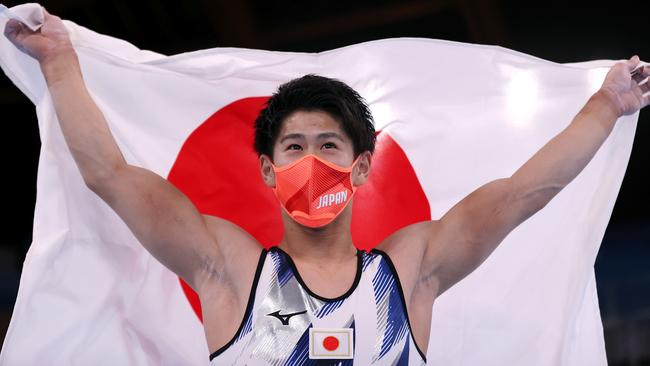 Daiki Hashimoto of Team Japan celebrates his victory with the Japan Flag during the Men's All-Around Final at the 2020 Olympics. Picture: Laurence Griffiths/Getty Images