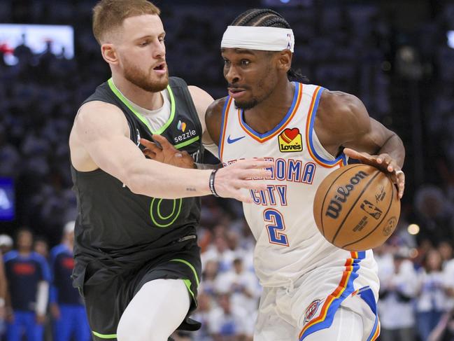 Oklahoma City Thunder guard Shai Gilgeous-Alexander (2) drives against Minnesota Timberwolves guard Donte DiVincenzo (0) during the second half of Game 1 of an NBA basketball Western Conference Finals playoff series Tuesday, May 20, 2025, in Oklahoma City. (AP Photo/Nate Billings)