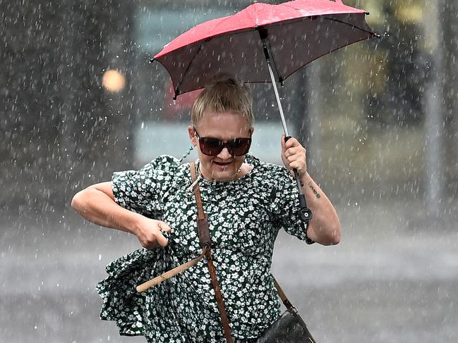 BRISBANE, AUSTRALIA - NewsWire Photos - FEBRUARY 2, 2021.People make their way through heavy rain in central Brisbane. A severe thunderstorm warning with possible flash flooding has been issued for the southeast, including Brisbane CBD, as wet weather causes traffic chaos on Tuesday morning.Picture: NCA NewsWire / Dan Peled