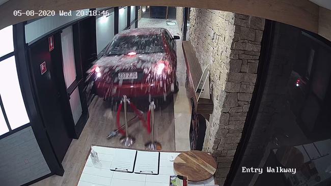 A still from a CCTV video showing Nathan Simpson driving his girlfriend's car through the front door of the Robina Pavilion in August 2020.