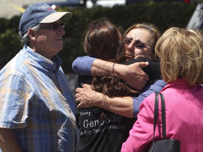 Members of the Chabad synagogue hug after the shooting. Picture: AP