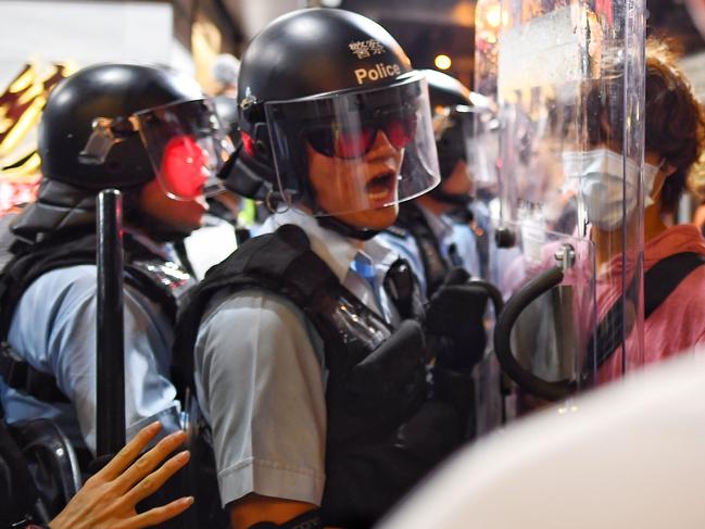 A policeman (L) shouts at a pro-democracy protester (R) to move out of his way during a gathering in the Sham Shui Po Area of Hong Kong. Picture: AFP