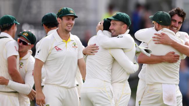 Australian players celebrate their Ashes victory on Monday.