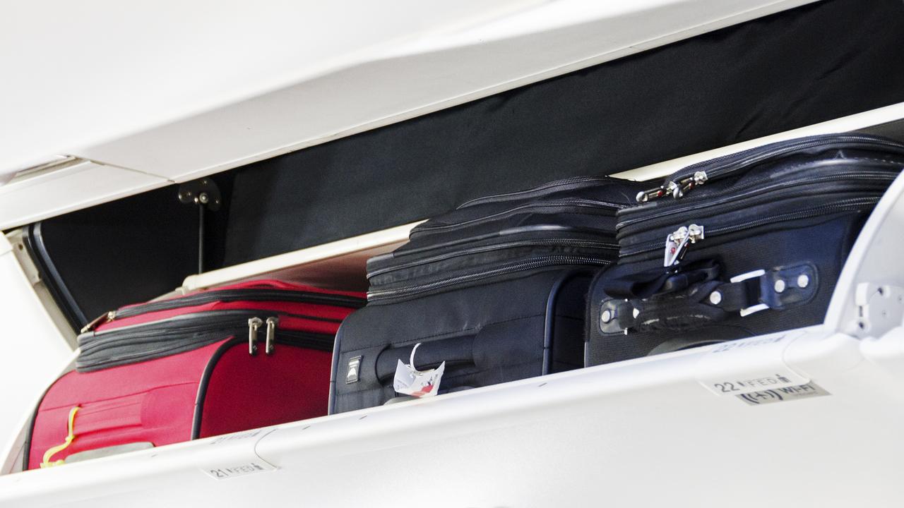 Carry on luggage in an overhead storage compartment on commercial plane. Picture: iStock