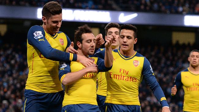 Arsenal's Spanish midfielder Santi Cazorla (2L) is congratulated.