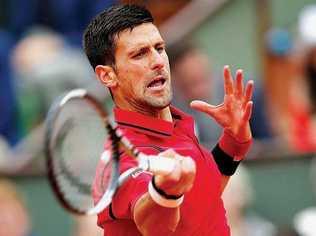 WARM FAVOURITE: Novak Djokovic of Serbia in action against Andy Murray of Britain during their men's singles final match at the French Open tennis tournament at Roland Garros in Paris. Picture: YOAN VALAT