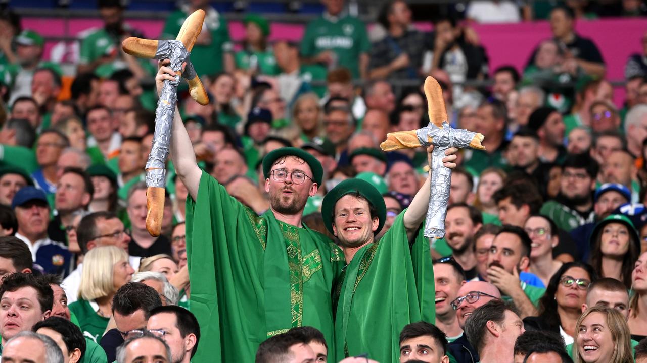 Fans of Ireland, wearing Green Berets and holding Cross shaped Baguettes, pose for a photo. (Photo by Stu Forster/Getty Images)