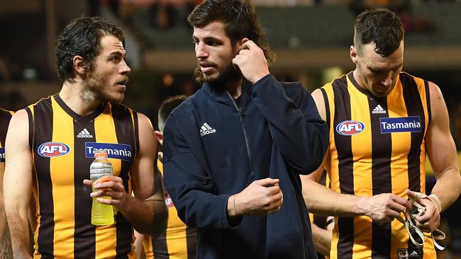 Isaac Smith chats with injured Hawk Ben Stratton.